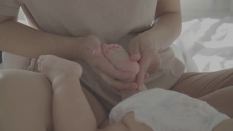 Mom-Massaging-And-Caressing-Her-Baby's-Feet