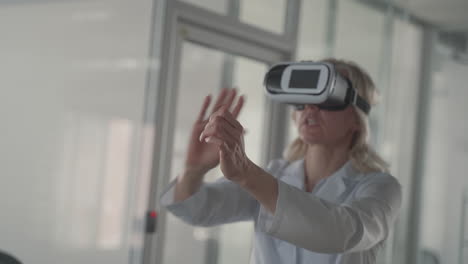 A-Blonde,-Middle-Aged-Female-Doctor-Navigates-Through-Data-With-Vr-Glasses