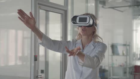 A-Blonde,-Middle-Aged-Female-Doctor-Navigates-Through-Data-With-Vr-Glasses-1