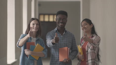 Multicultural-Group-Of-University-Students-Smiling-And-Thumbing-Up