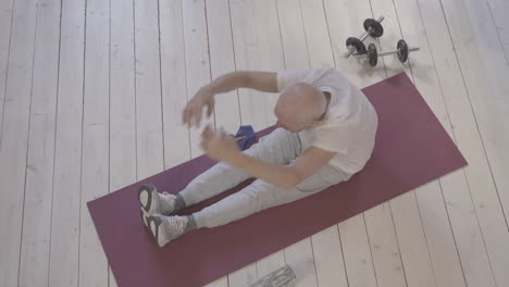 Old-Man-Stretching-And-Exercising-On-Yoga-Mat-At-Home-2