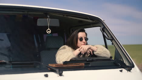 A-Pretty-Girl-With-Sunglasses-At-The-Wheel-Of-A-Caravan-Stopped-On-A-Lost-Road-In-The-Middle-Of-The-Countryside-1