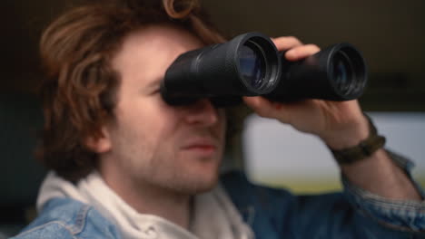 Young-Boy-Looks-With-A-Pair-Of-Binoculars-From-A-Car