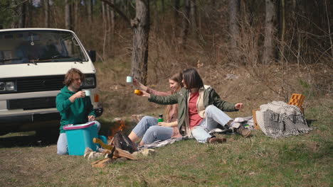 Two-Young-Girls-And-A-Young-Boy-Have-A-Good-Time-In-The-Forest-Having-A-Hot-Beverage-1