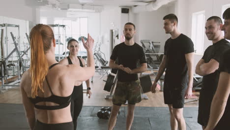 Strong-Young-Female-High-Fives-Her-Pupils-In-The-Gym