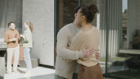 A-Young-Male-Gives-A-Welcome-Home-Hug-To-An-Afroamerican-Beautiful-Female