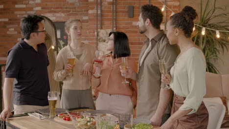 A-Nice-Multiethnic-Group-Of-Friends-Conversing-At-A-Dinner-Party