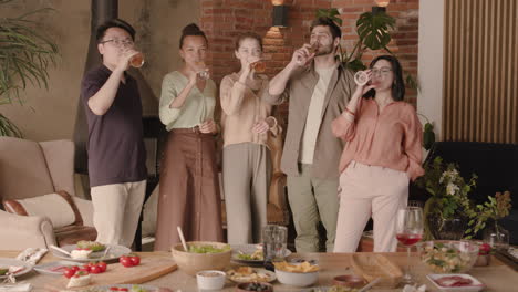 A-Multiethnic-Group-Of-Friends-Toast-With-Their-Glasses-At-A-Dinner-Party