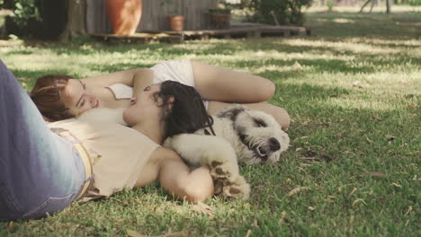Females-Lying-With-A-Big-Dog-On-The-Grass