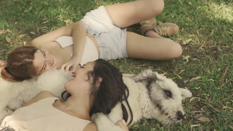 Females-Lying-With-A-Big-Dog-On-The-Grass-1
