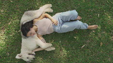 Female-Lying-With-Her-Big-Dog-On-The-Grass-1