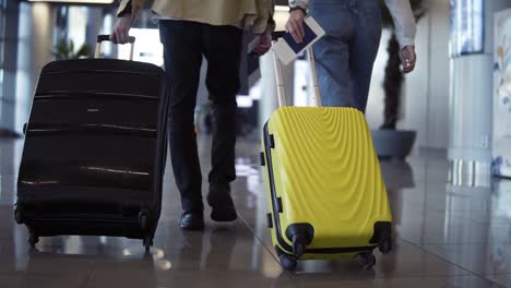 Pair-Of-Travelers-Are-Carrying-Their-Luggage-And-Passports