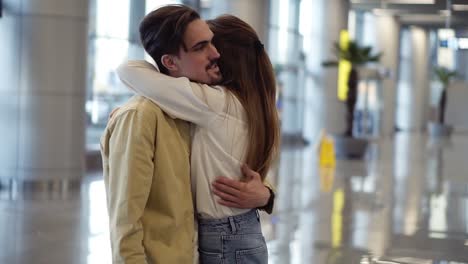 Excited,-Woman-Showing-Passport-With-Visa-Stamp-To-Her-Boyfriend-At-The-Airport