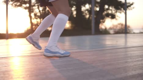 Close-Up-Of-Female-Basketball-Player-Legs-In-White-Golf-Socks-Doing-Dribbling-Exersice-Very-Quickly,-Run-Backwards,-Training-Outdoors-On-The-Local-Court