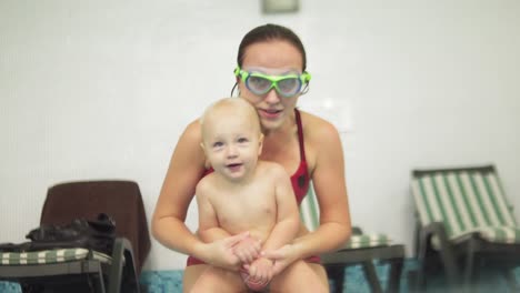 Cute-Blonde-Toddler-Is-Diving-Under-The-Water-Together-With-His-Mother-In-Special-Protective-Glasses-In-The-Swimming-Pool