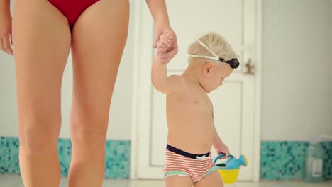 Young-Mother-And-Her-Cute-Little-Blonde-Child-Walking-Near-Swimming-Pool