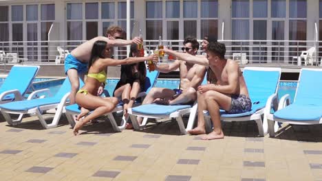 Group-Of-Beautiful-Young-People-Drinking-Cocktails-And-Having-Fun-At-The-Swimming-Pool