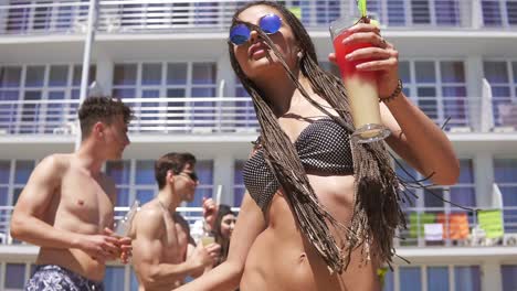 Young-Beautiful-Girl-With-Dreads-And-Sunglasses-Coming-Clother-To-Camera-While-Dancing-On-The-Pool-Party-2