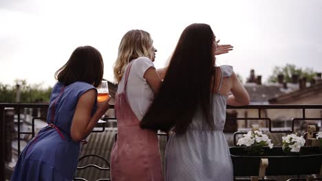 Three-Female-Friends-Enjoying-Hen-Party-On-The-Terrace,-Backside-View