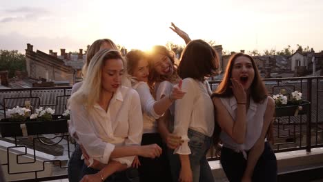 Close-Up-Of-Fashionable-Girls-In-The-Same-Casual-Clothes-Seductively-Dancing,-Posing-In-Front-Of-The-Camera-On-The-Terrace