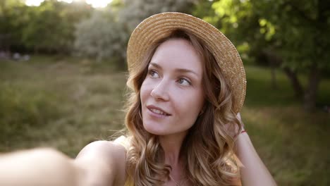 Young-Blonde-Woman,-Making-Selfie-In-Straw-Hat,-Funny-Face,-Posing-At-Countryside-At-Summer-Day
