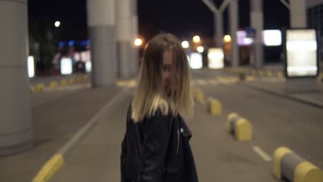 Footage-From-Backside-Of-Beautiful-Young-Woman-Walking-Freeby-An-Empty-Road-In-Urban-City