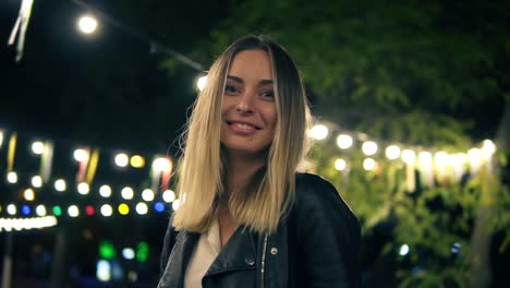 Portrait-Of-A-Beautiful-Girl-In-A-Black-Leather-Jacket-Standing-In-The-Night-Park