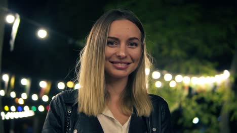 Portrait-Of-A-Beautiful-Girl-In-A-Black-Leather-Jacket-And-White-Blouse-Standing-In-The-Night-Park