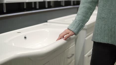 Woman-Is-Choosing-A-New-Ceramic-Sink-In-A-Store