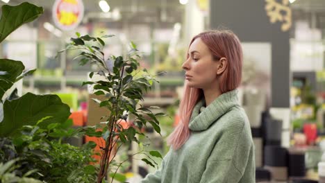 Blonde-Woman-Choosing-Plants-At-Flower-Market-In-Garden-Shop