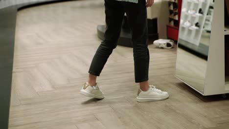 Woman-Fits-New-White-Sneakers-In-Shoe-Store,-Trying-Best-Size