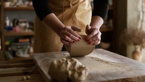Close-Up-Footage-Of-Female-Hands-With-Beautiful-Red-Manicure-Holding-Clay-And-Kneading-It-On-A-Worktop-1