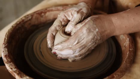 Close-Up-Of-Potter's-Hands-With-Red-Manicure-Working-With-Wet-Clay-On-A-Pottery-Wheel-Making-A-Clay-Product-In-A-Workshop-2