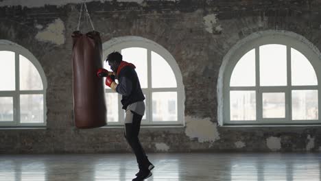 Full-Length-Of-A-Boxer-Training-At-Boxing-Studio-In-Gloves