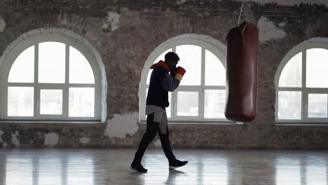 Full-Length-Of-A-Boxer-Training-At-Boxing-Studio-In-Gloves-At-Loft-Studio