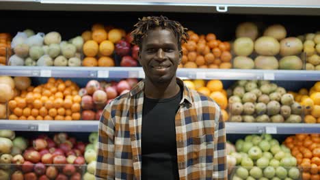 Portrait-Of-Handsome-Young-Man-Looking-At-Camera-And-Smiling-In-Supermarket