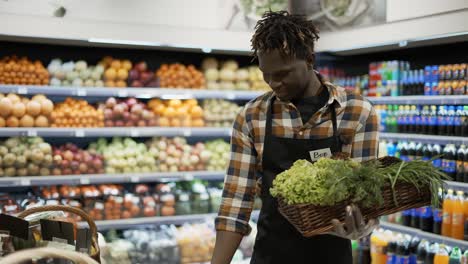 Smiling-Worker-Arranging-Greens-In-The-Supermarket