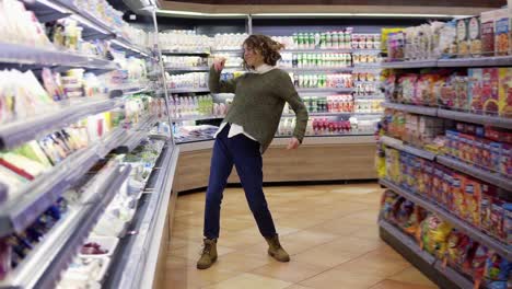 Full-Length-Footage-Of-Young-Woman-Dancing-Through-Grocery-Store-Aisles
