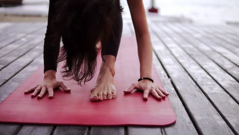 Close-Up-Footage-Of-A-Sportswoman-Doing-Yoga-Or-Stretching-On-Mat-Outdoors-Leaning-Torso-Forward
