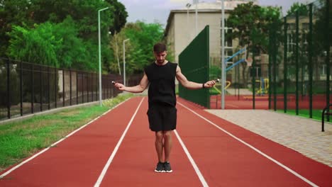 Fit,-Bearded-Man-Standing-On-Running-Track-Outdoors-On-Modern-Stadium-Doing-Exercise-With-Skipping-Rope