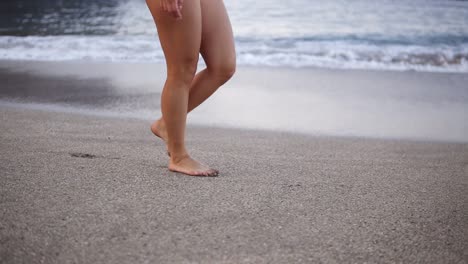 Female-Sporty-Legs-Tourist-Walking-Barefoot-On-Shore-At-Sunset