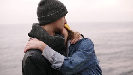 Hipster-Young-Happy-Couple-Standing-Together-And-Hugging-At-The-Seaside