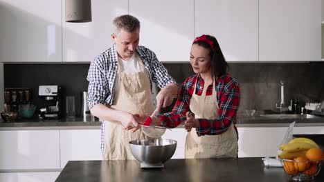The-Couple-Sifting-Flour-To-Make-Bread-And-Bakery-In-Kitchen