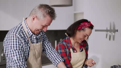 Cheerful-Couple-Cooking-Together-With-Fun-And-Smiling
