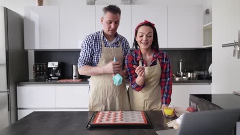 Couple-At-Kitchen-Making-Macaroons-At-Home,-Talking-On-Camera