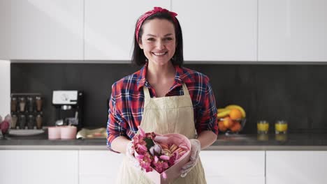 Woman-In-Apron-Presents-Box-With-Macaroons-Cookies-Decorated-With-Flowers