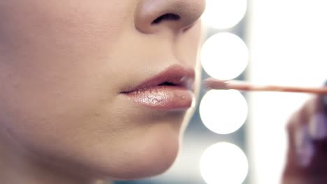 Closeup-View-Of-A-Professional-Makeup-Artist-Applying-Lipstick-On-Model's-Lips-Working-In-Beauty-Salon