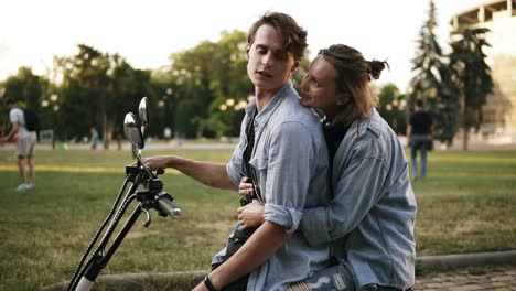 Loving-Couple-Spending-A-Relaxing-Moment-Together-Sitting-On-Minibike-In-A-Close-Embrace