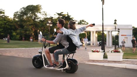 Young-Man-And-Her-Girlfriend-Are-Riding-An-Electric-Bile-In-The-Crowdy-Green-Park