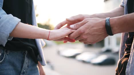 Close-Up-Footage-Of-Young-Couple-Holding-Hands-Having-Date-In-The-Park